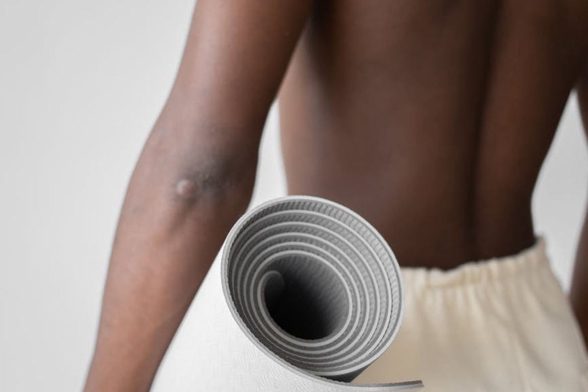 Wide view of a clean minimal yoga studio space.